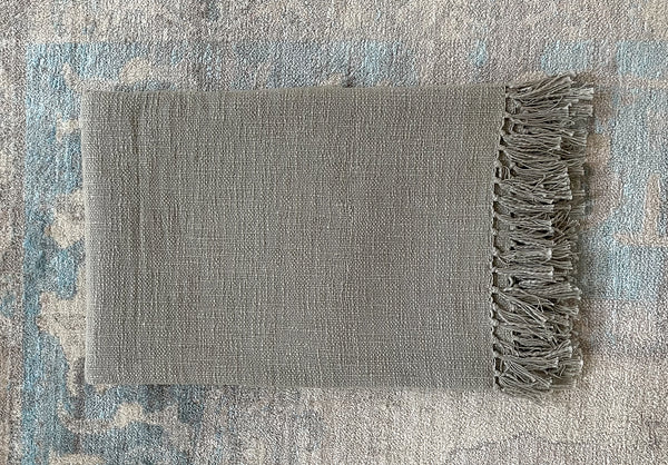 Simple timeless comfortable hand woven light grey cotton throw.